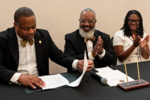Signatories : Dr. Bugg, CEO & Library Director and Leadership of Alpha Phi Alpha Fraternity